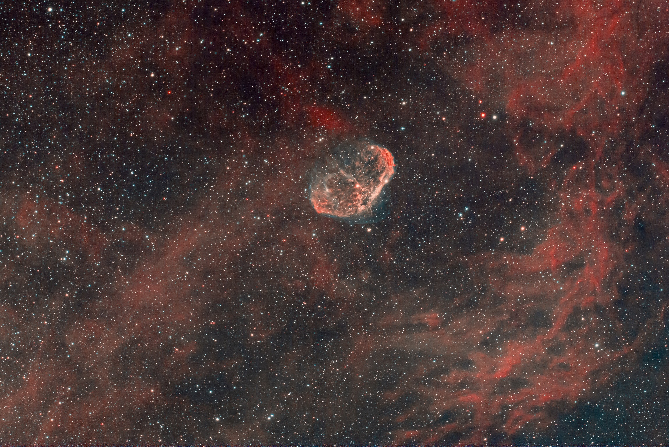 The Crescent Nebula is an emission nebula in the constellation Cygnus, about 5000 light-years away. It is cosmic bubble about 25 light-years across, blown by winds from its central, bright, massive star. It combines a composite color image with narrow band data that isolates light from hydrogen and oxygen atoms in the wind-blown nebula.