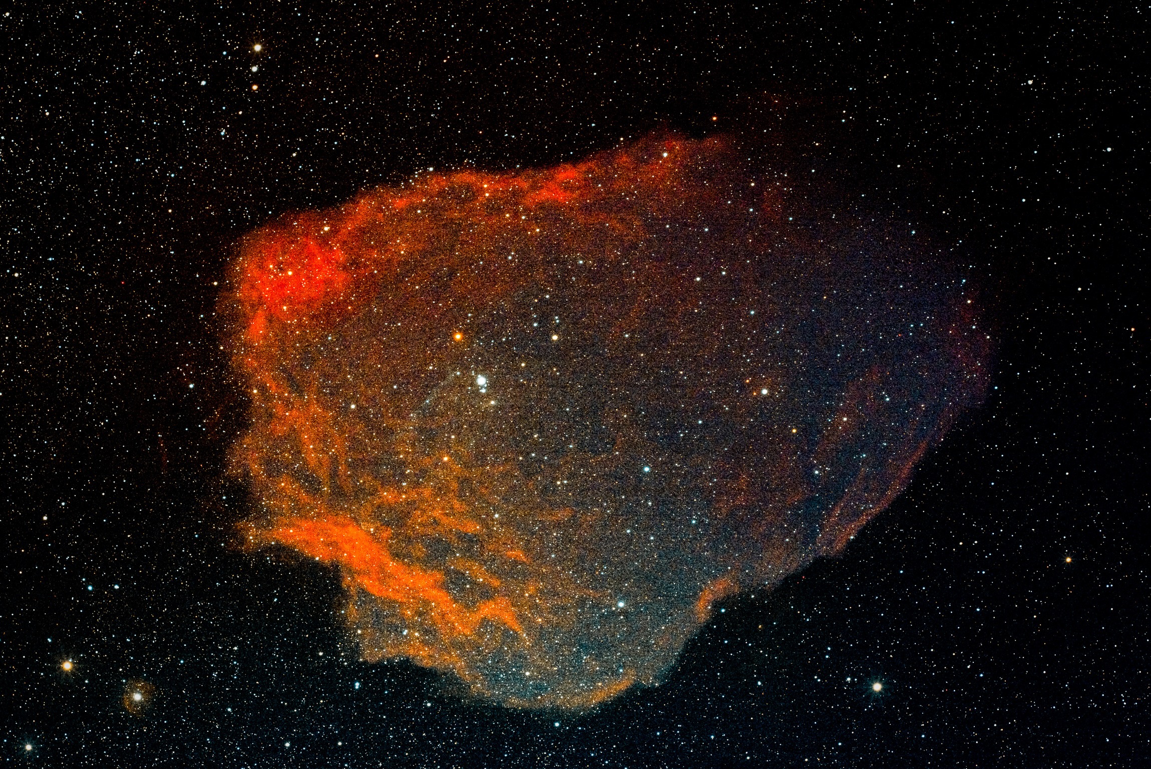 THE FLYING BAT AND SQUID NEBULAE. Around 2000 light-years from Earth is the Flying Bat Nebula (Sh2-129), seen here as a huge cloud of red hydrogen gas. Within this is the glowing blue Squid Nebula (OU4), thought to be a low-mass star near the end of its life, blasting its outer layers off in two opposite directions.
