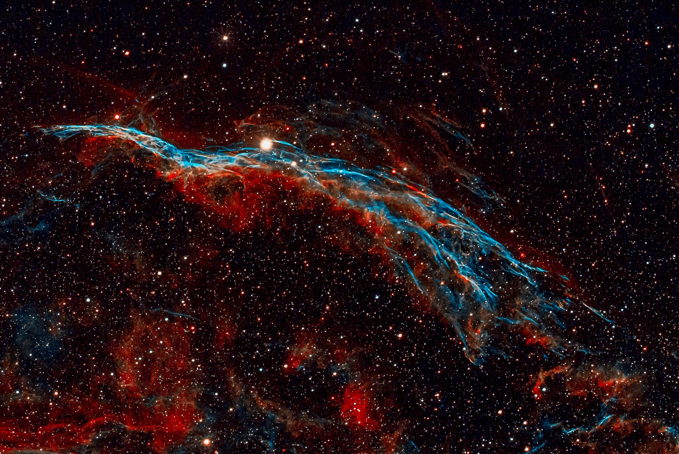 The Western Veil Nebula is a supernova remnant consisting of oxygen, sulfur, and hydrogen gas. This area of Cygnus is densely populated with stars and includes regions of heated gas that make up the Cygnus Loop.